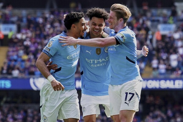 Manchester City manager Pep Guardiola celebrates their side's second goal of the game during a Premier League soccer match between Manchester City and Aston Villa, Tuesday, April 22, 2025, at the Etihad Stadium in Manchester, England. (Martin Rickett/PA via AP)