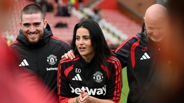 Eva Olid stands in a circle at the end of a Manchester United match